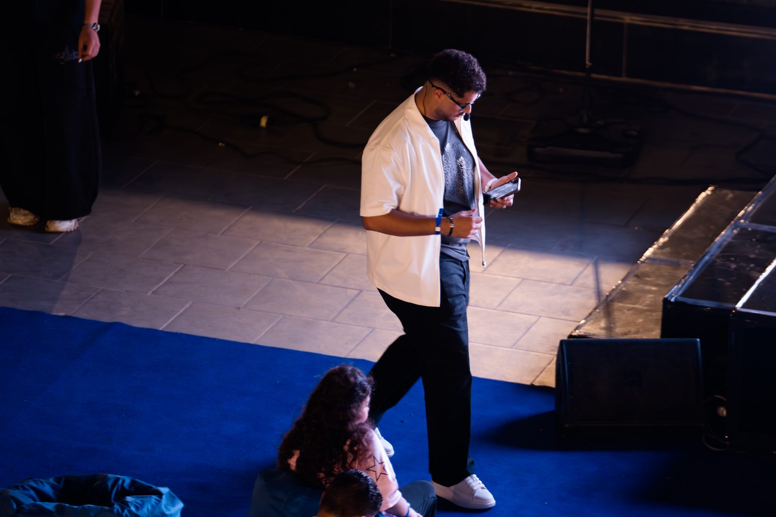 The host walking across the stage during the Matgarak launch event